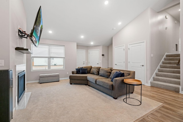 living room featuring light hardwood / wood-style flooring and high vaulted ceiling