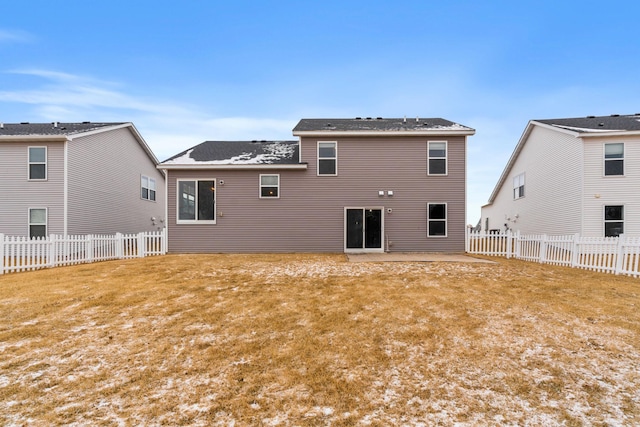 rear view of house with a patio and a lawn