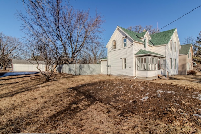 view of side of property featuring a sunroom