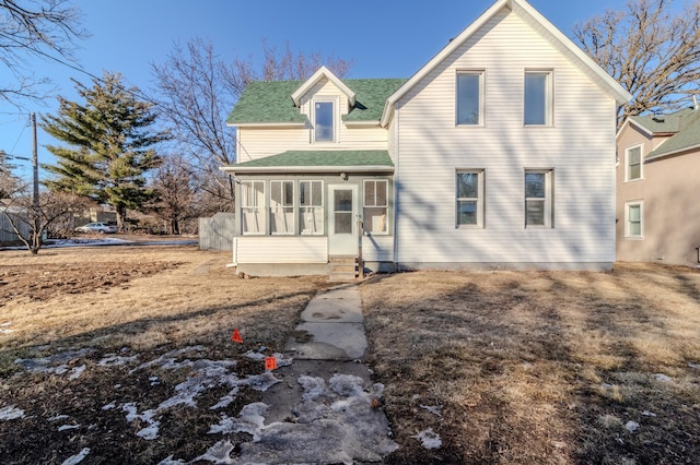 rear view of house featuring a sunroom