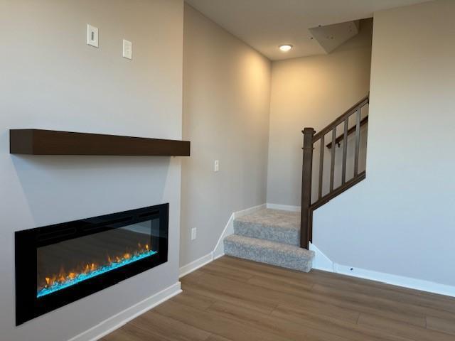 stairs featuring hardwood / wood-style flooring