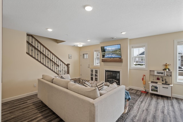 living room featuring dark hardwood / wood-style floors and a textured ceiling