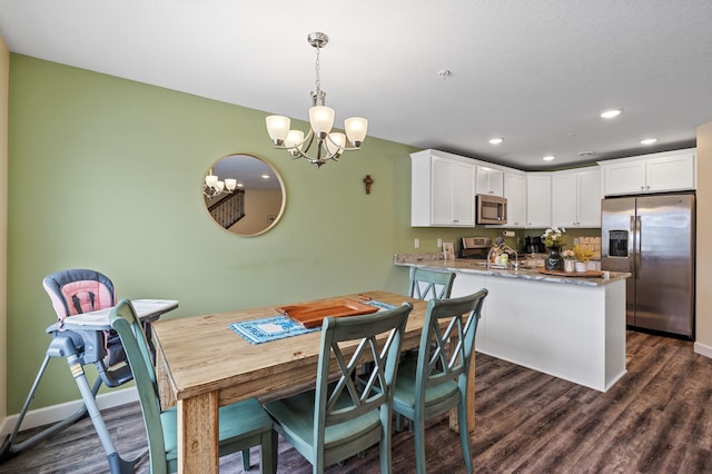 dining room featuring dark wood-type flooring and a chandelier