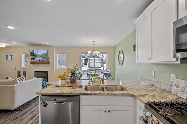 kitchen with stainless steel appliances, sink, and white cabinets