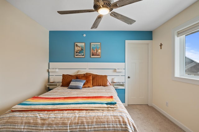 bedroom with ceiling fan and light carpet