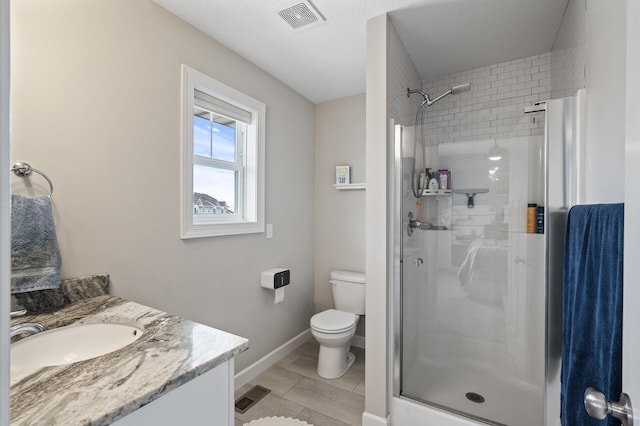 bathroom with vanity, an enclosed shower, and toilet