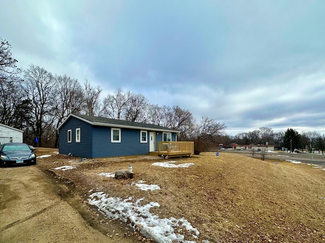 view of side of property featuring a wooden deck