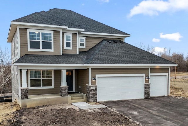 view of front of house with a garage, a shingled roof, driveway, and stone siding