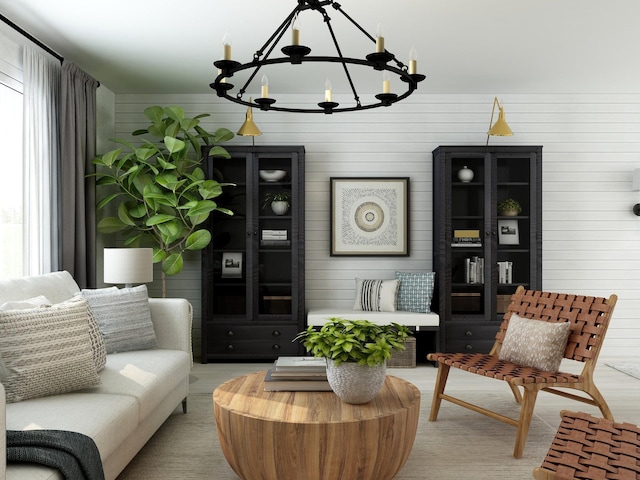 living area featuring wooden walls, a notable chandelier, and a wealth of natural light