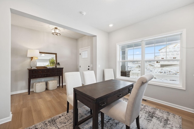 dining room featuring baseboards, recessed lighting, and wood finished floors