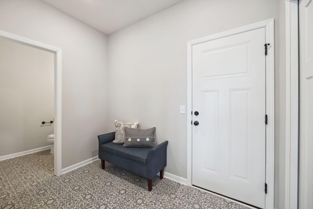 doorway to outside with baseboards and light floors