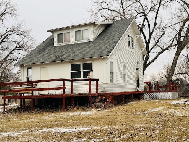 back of property featuring a deck