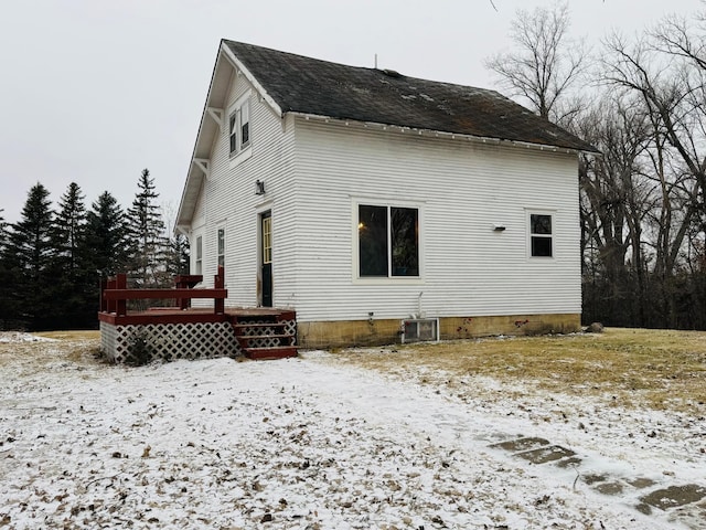 view of snow covered exterior with a deck