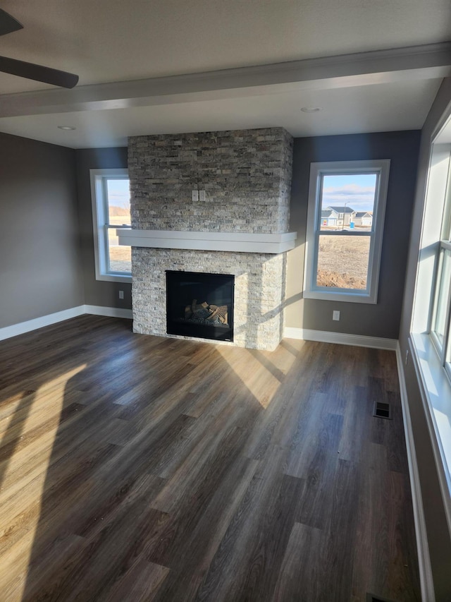 unfurnished living room featuring ceiling fan, hardwood / wood-style floors, and a fireplace