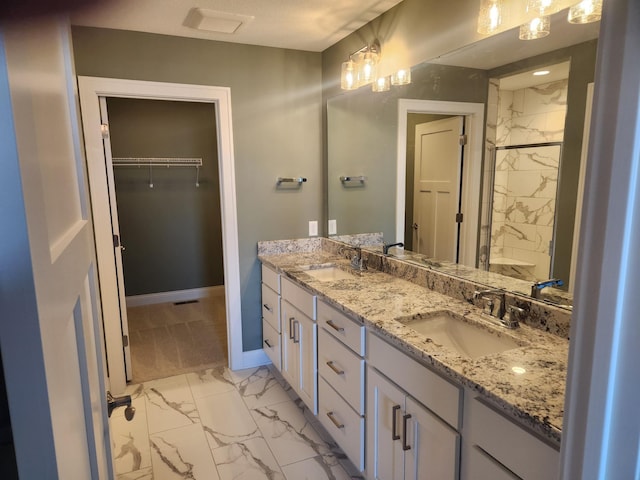 bathroom with a shower with door and vanity