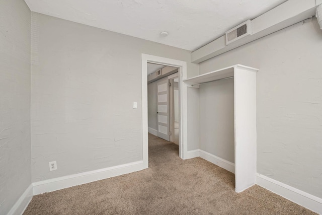 unfurnished bedroom with carpet floors and a closet