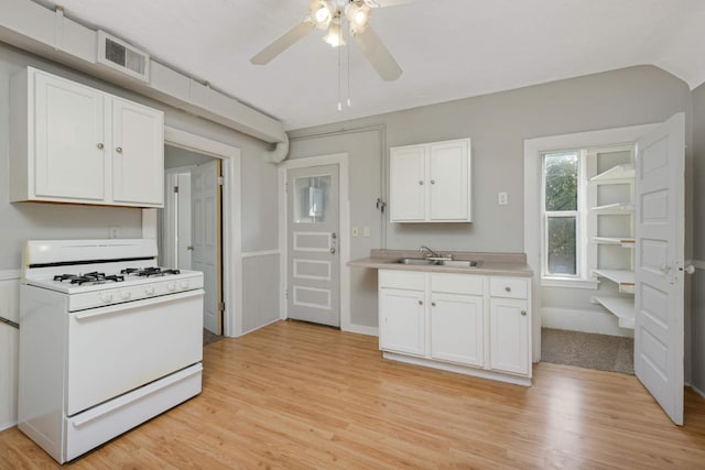 kitchen featuring sink, white cabinets, white range with gas stovetop, ceiling fan, and light wood-type flooring