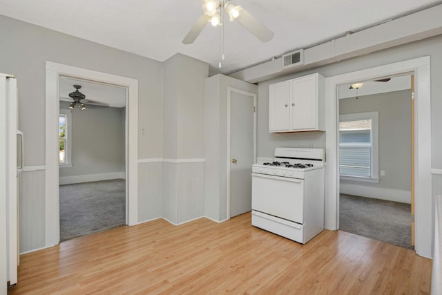 kitchen featuring ceiling fan, white appliances, white cabinets, and light wood-type flooring