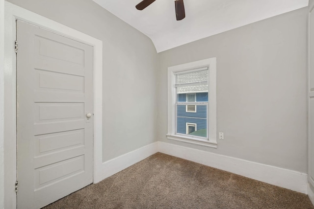 spare room with ceiling fan, lofted ceiling, and carpet flooring