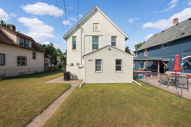 back of property with a lawn