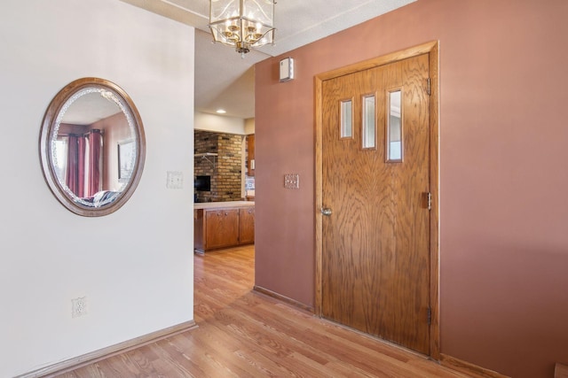 entrance foyer featuring a notable chandelier and light wood-type flooring