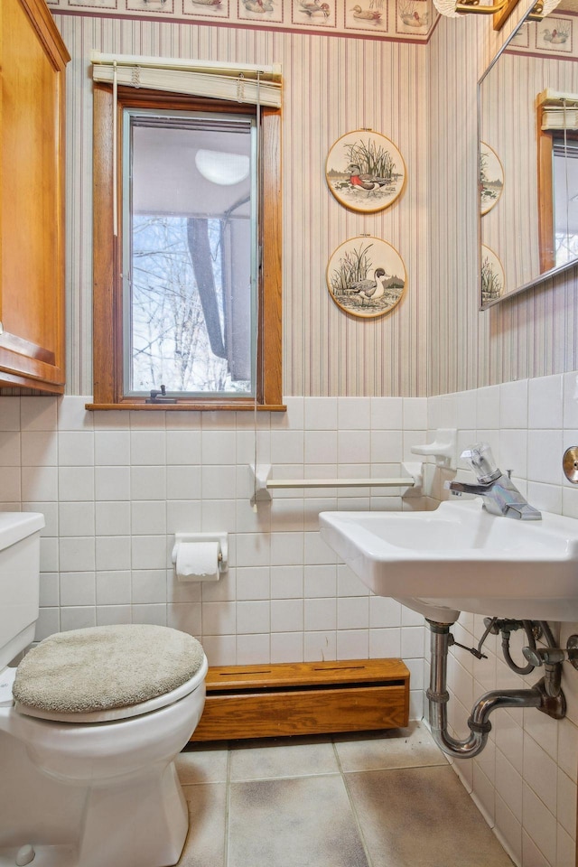 bathroom featuring tile walls, sink, tile patterned floors, and toilet