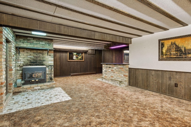 basement with bar area, wooden walls, and carpet flooring