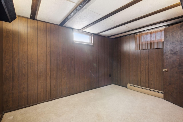 basement featuring a baseboard heating unit, light carpet, and wood walls