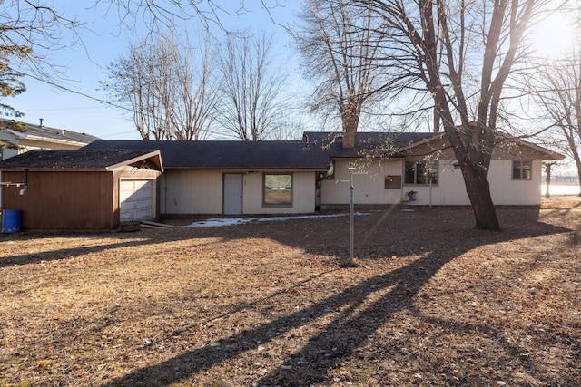 back of property with a garage