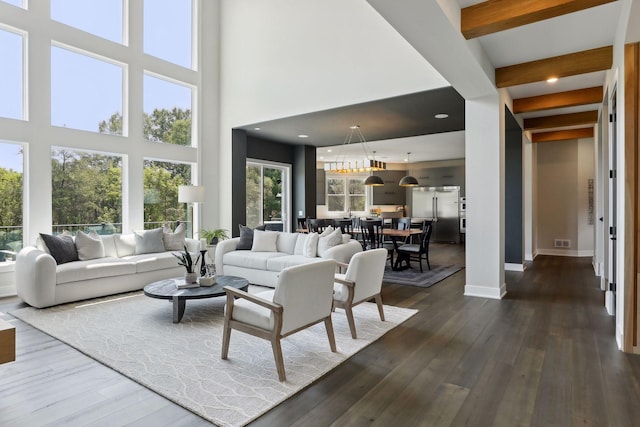 living room featuring beamed ceiling and dark hardwood / wood-style flooring