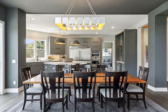 dining room with sink and dark hardwood / wood-style floors