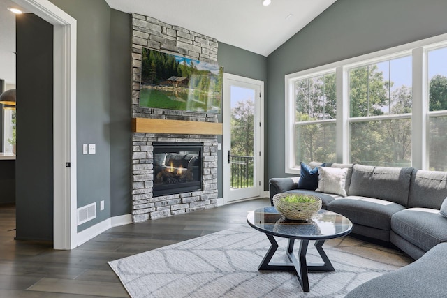 living room featuring dark wood-type flooring, lofted ceiling, and a fireplace