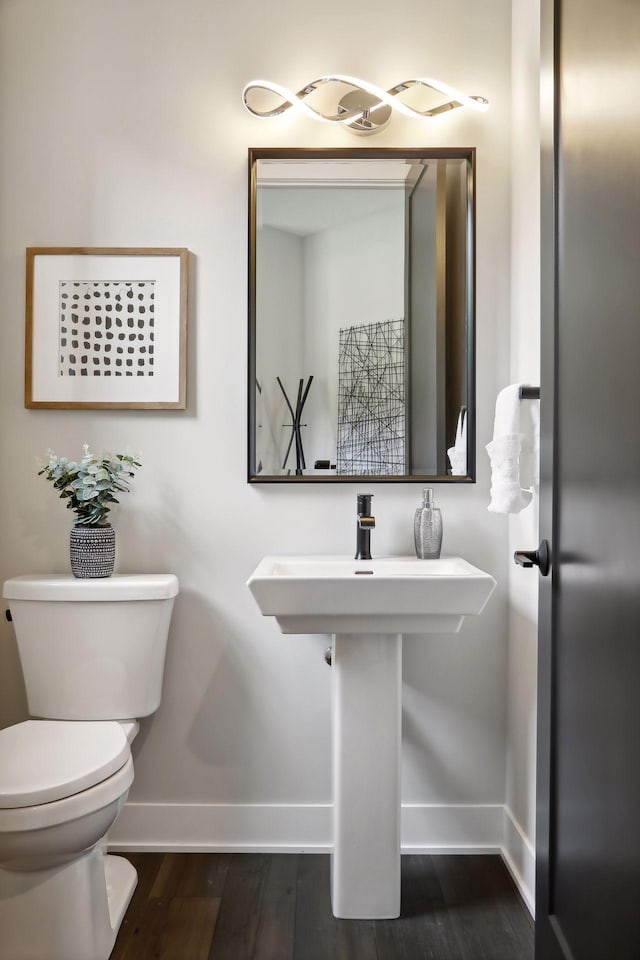 bathroom featuring hardwood / wood-style floors and toilet