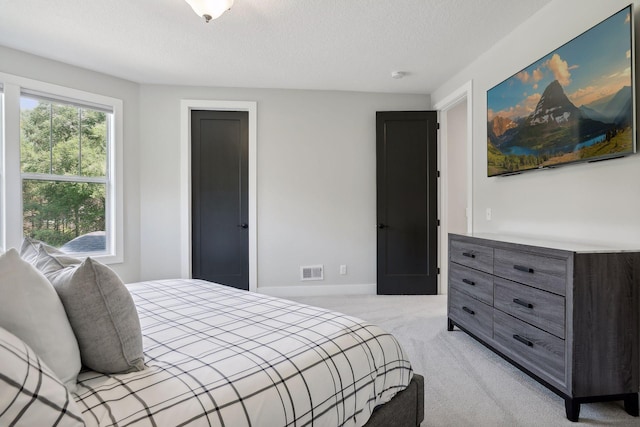 carpeted bedroom featuring a textured ceiling