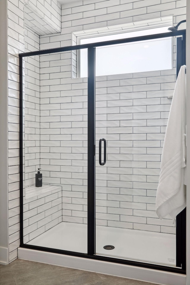 bathroom with a shower with door