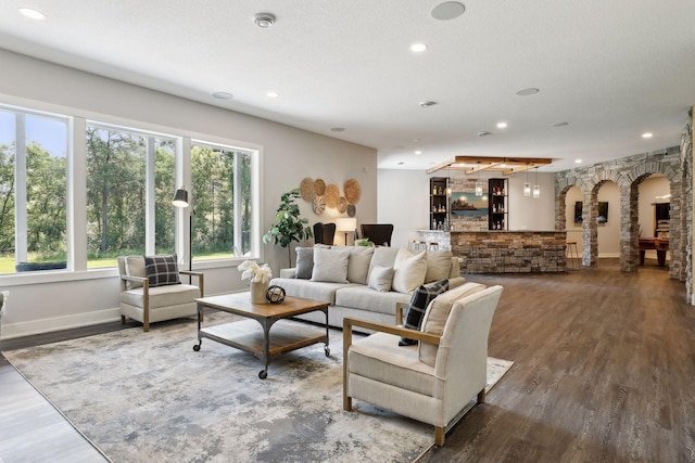 living room with dark hardwood / wood-style flooring and a textured ceiling