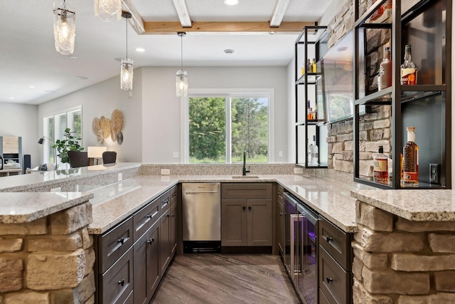 kitchen with wine cooler, sink, light stone countertops, and kitchen peninsula