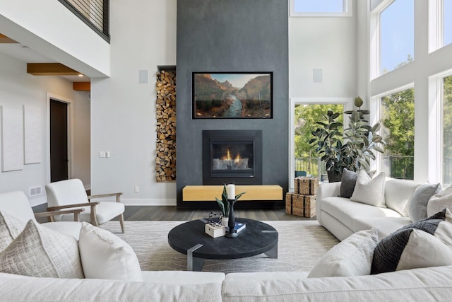 9533 Otchipwe Ave N, Stillwater, MN 55082 - living room featuring a wealth of natural light, a fireplace, wood finished floors, and a towering ceiling