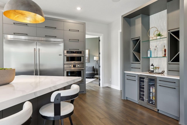 9533 Otchipwe Ave N, Stillwater, MN 55082 - kitchen featuring appliances with stainless steel finishes, dark wood finished floors, gray cabinetry, baseboards, and wine cooler