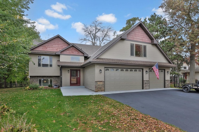 craftsman house with a garage and a front yard