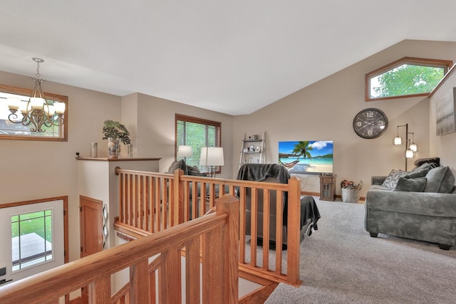 living room with lofted ceiling, carpet floors, and an inviting chandelier