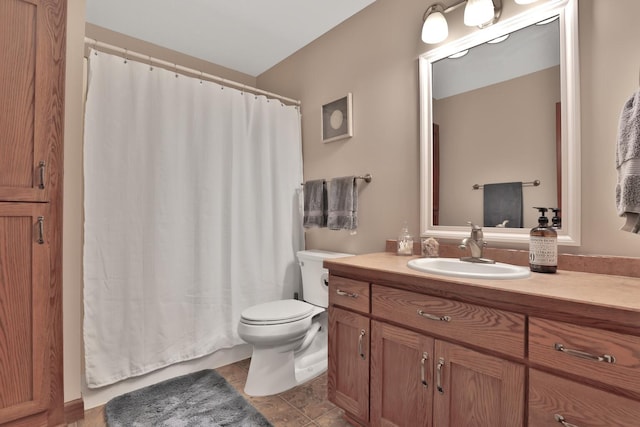 bathroom with vanity, tile patterned flooring, and toilet