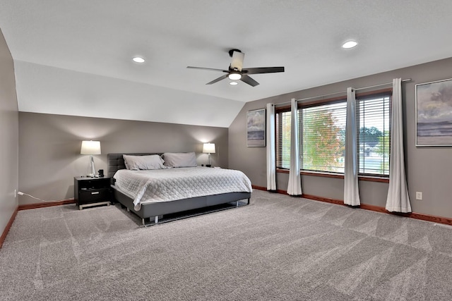 bedroom with ceiling fan, light colored carpet, and vaulted ceiling