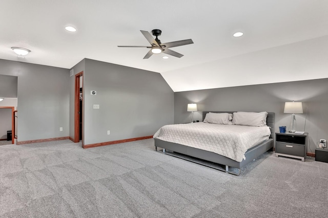 bedroom with ceiling fan, vaulted ceiling, and light carpet