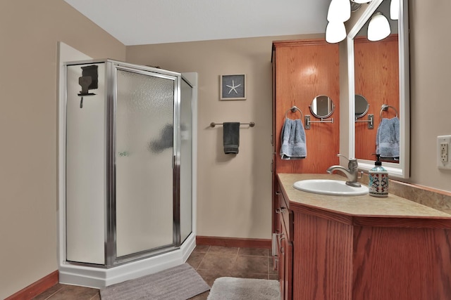 bathroom with an enclosed shower, vanity, and tile patterned floors