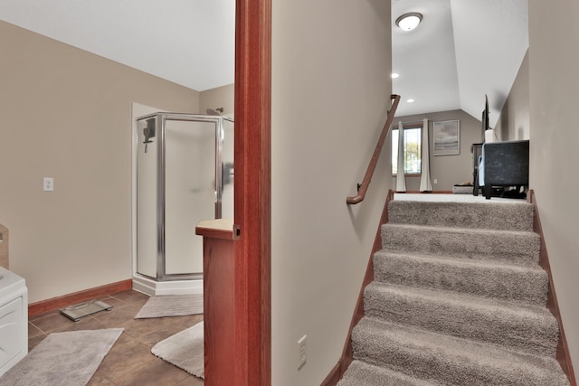 stairway with lofted ceiling and tile patterned flooring