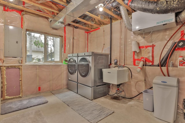 laundry room with sink, electric panel, and independent washer and dryer