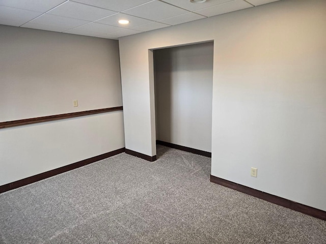 unfurnished bedroom with carpet and a drop ceiling