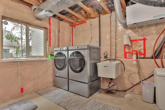 clothes washing area with sink and washing machine and dryer