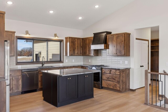 21933 Edison Ct, East Bethel, MN 55011 - kitchen with sink, dark stone counters, a center island, stainless steel appliances, and custom range hood